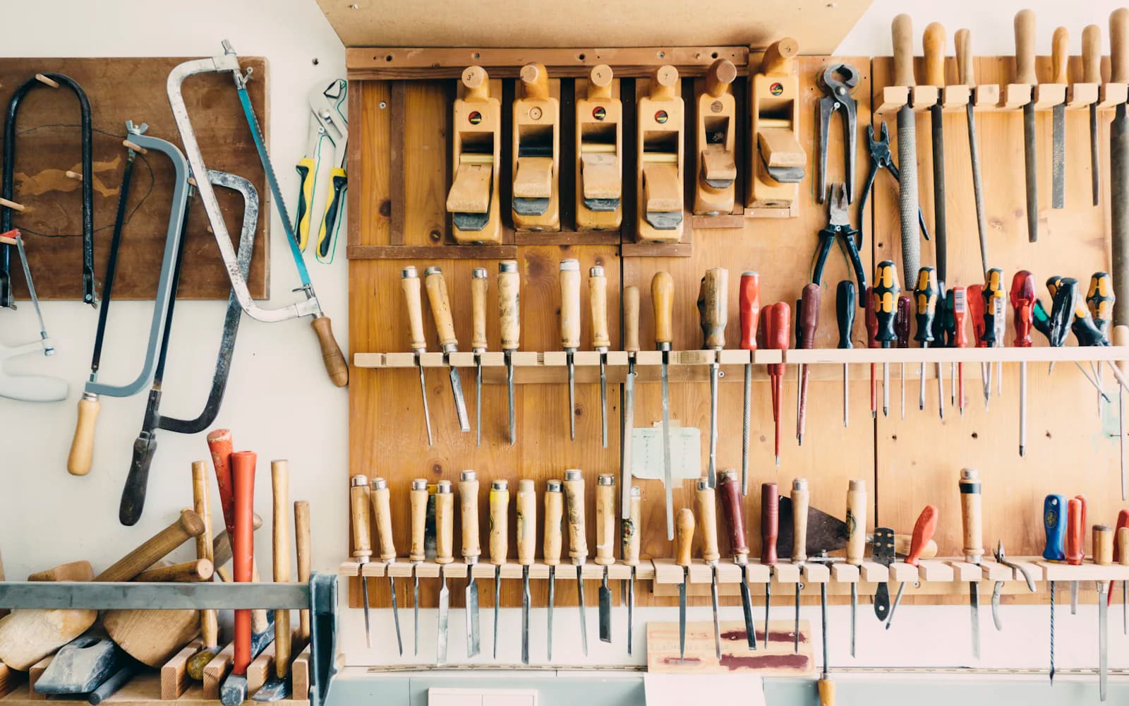 Hand tools hanging on a workshop wall