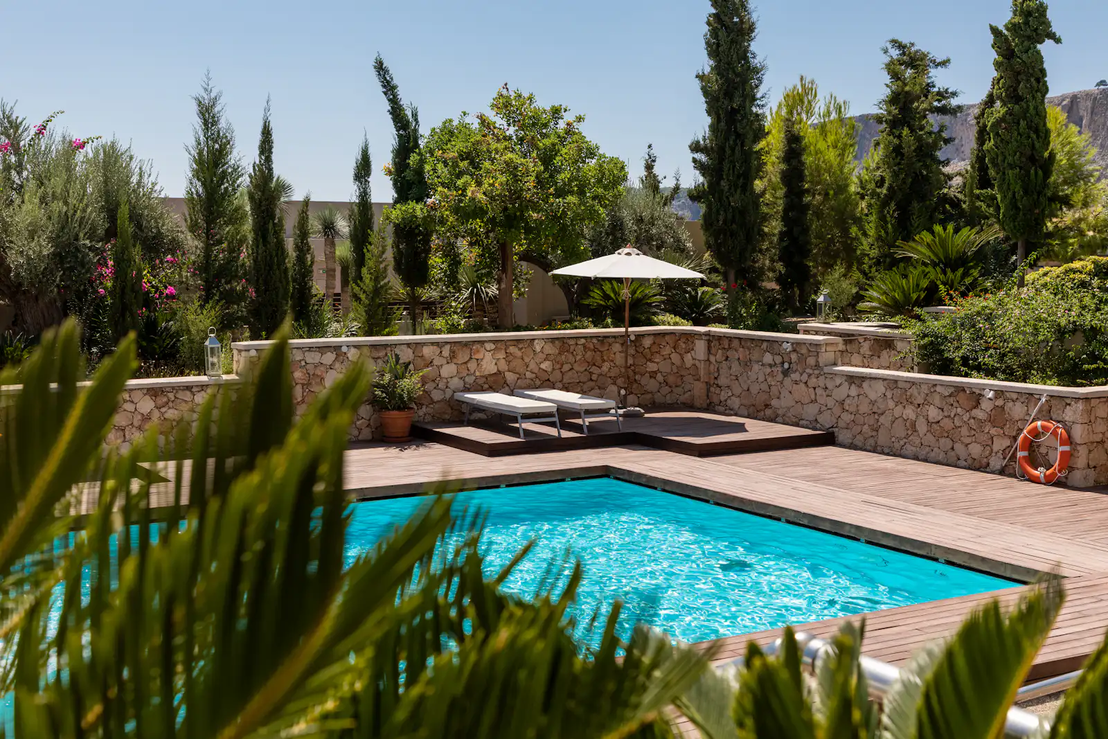 A clean backyard pool on a sunny day